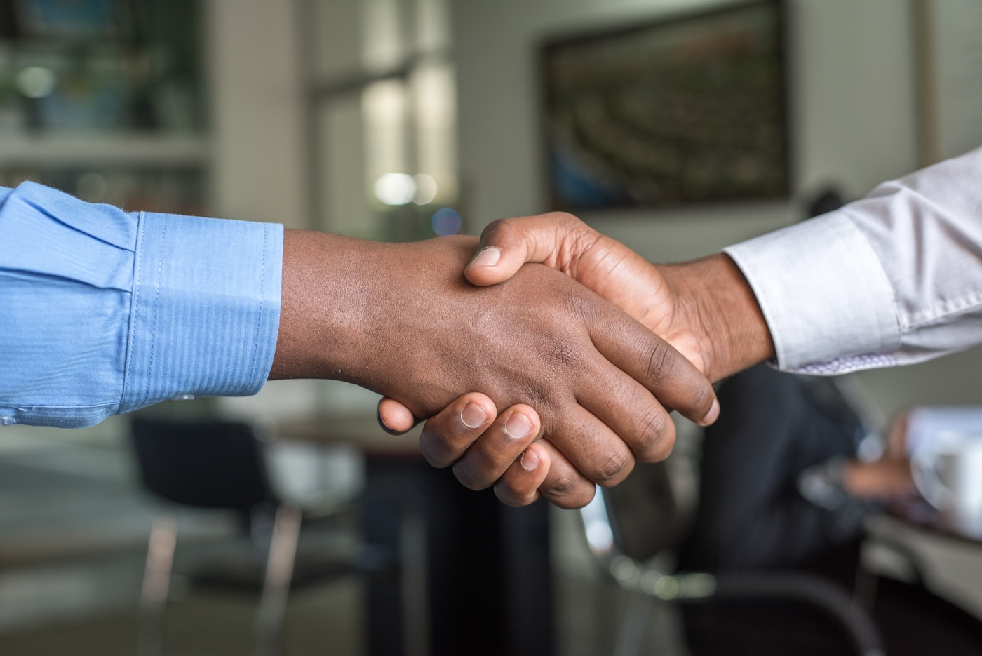 Customer service and business handshake in office